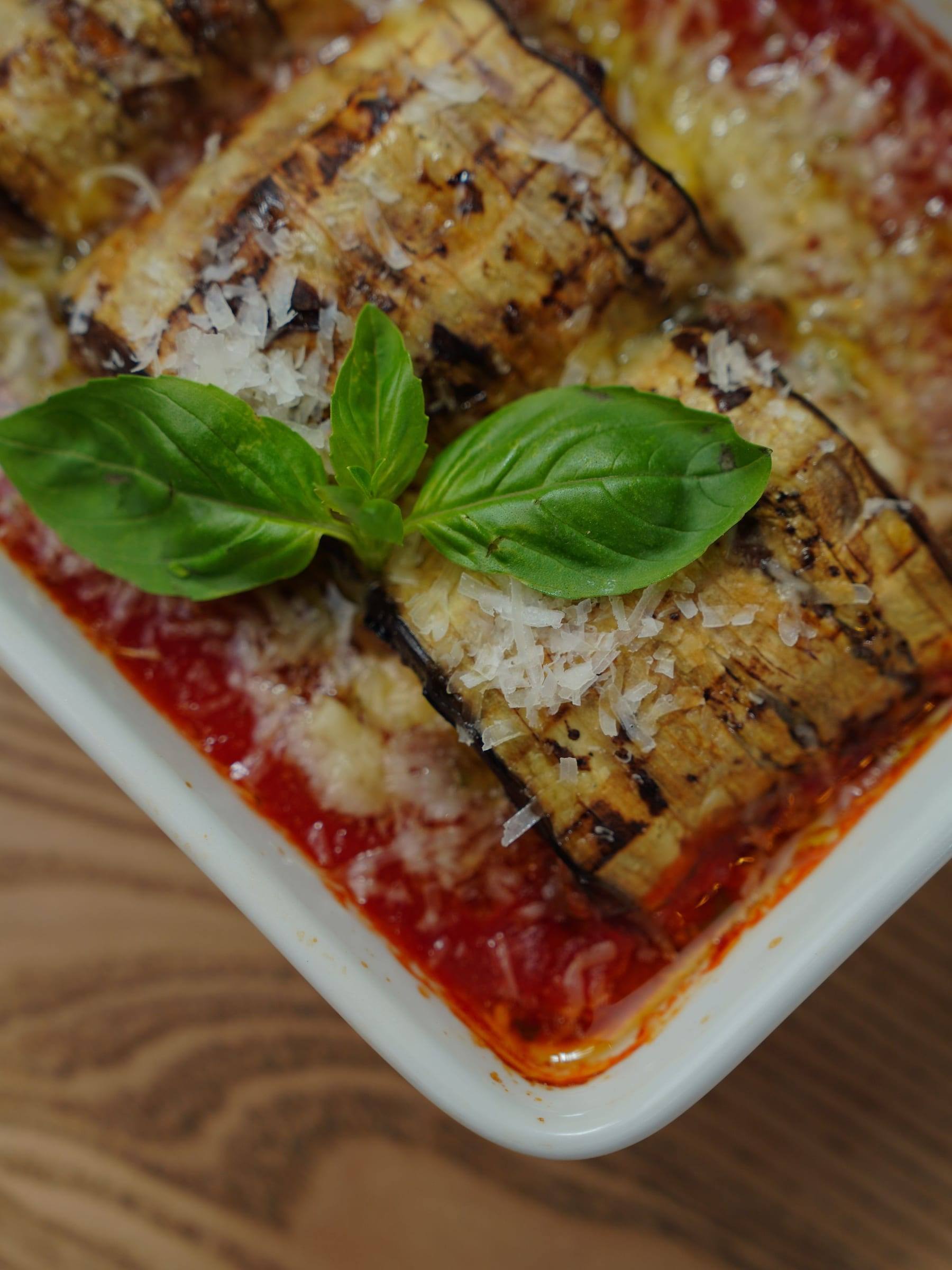 Überbackene Auberginen mit Tomatensauce, Käse und frischem Basilikum